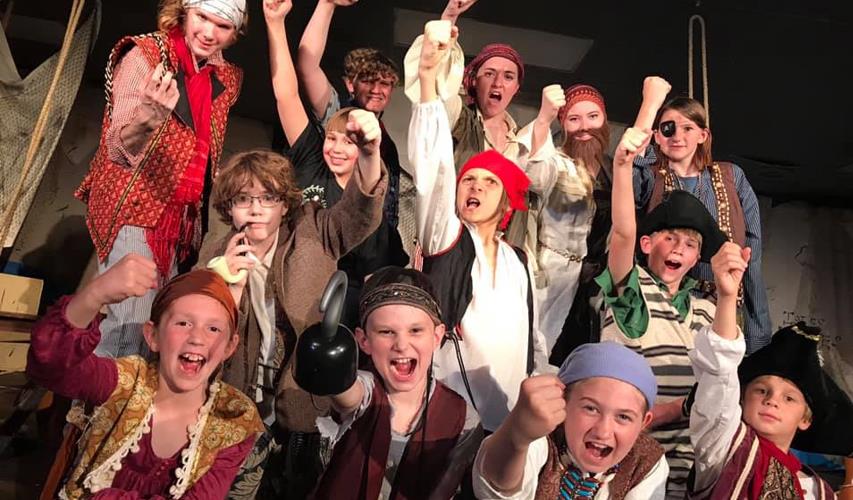 Kids play pirates in Halloween play